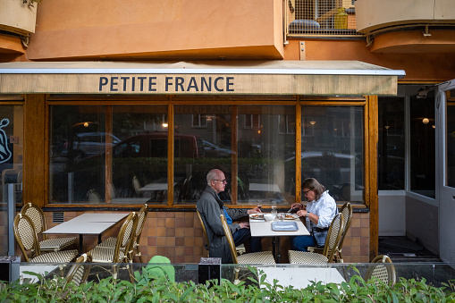 Stockholm, Sweden Aug 29, 2023 Customers sit outside at a French bakery called Petite France on Kungsholmen.