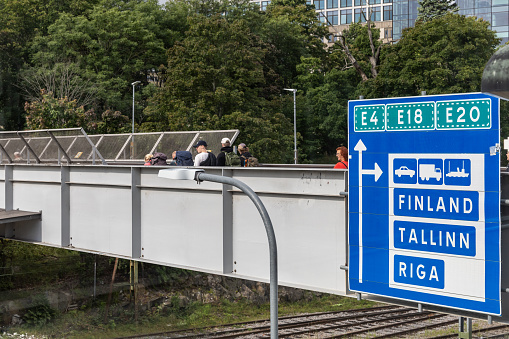 Stockholm, Sweden Aug 24, 2023 A large road sign on a pedestrian bridge in the Vartahamnen port district points to ferries to Finland, Estonia and Latvia.