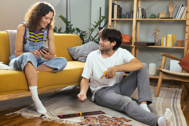 istock Young couple playing a board game and enjoying 1685589360
