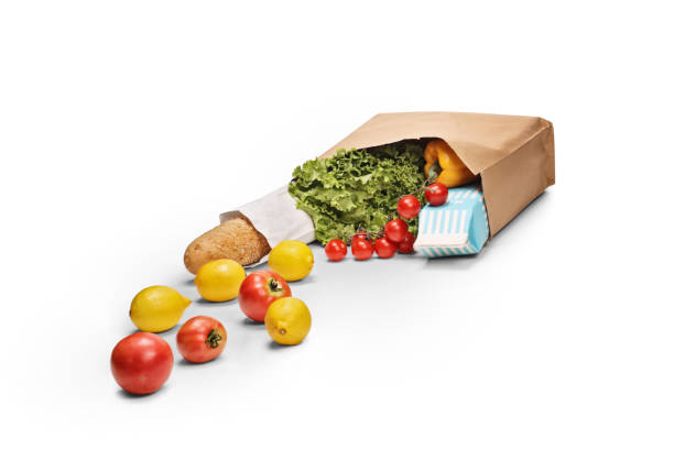 Grocery bag on the ground with products falling isolated on white background