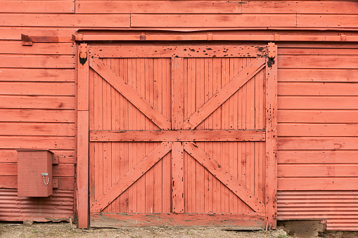 A close up of red sliding barn door.