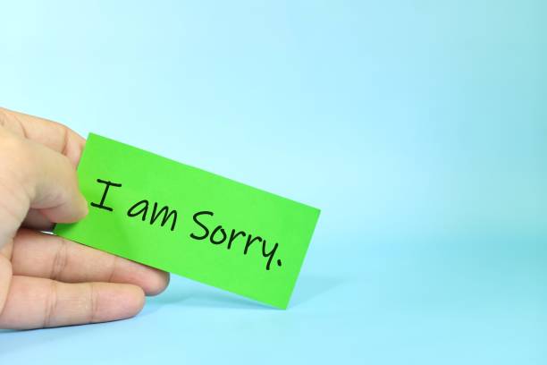 istock I am sorry message concept. Hand holding a bright yellow paper with written message note. 1685750949