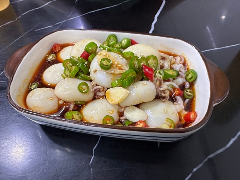 Baby cuttlefish in spicy sauce, mixed with soy sauce, garlic slices and chili . Chinese food style.