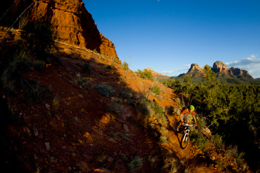 A male cyclist enjoys a mountain bike ride on a popular trail in Sedona, Arizona, USA.