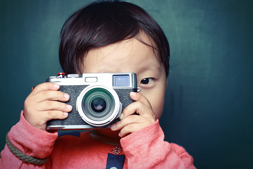 cute child plays the photographer