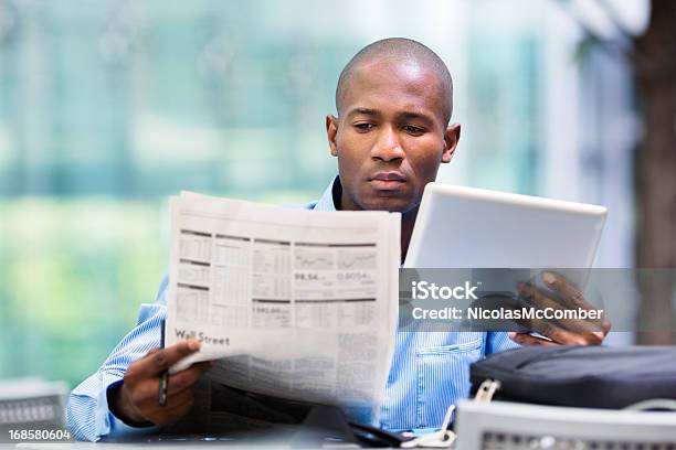 Investor Compares Quotes From Newspaper And Tablet Stock Photo - Download Image Now - Newspaper, Reading, Financial Occupation