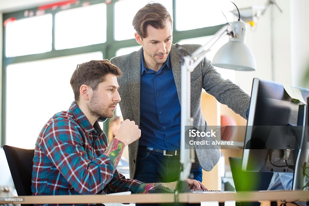 Two colleagues at a start up enjoying work Two young adults working at a start up, or perhaps students, enjoying their discussionshttp://www.zweig-industries.de/bilder/lightbox-istock/hhp8startup.jpg Adult Stock Photo