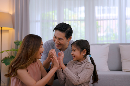 Couple with daughter make leisure activity together. Family and relationship concept.