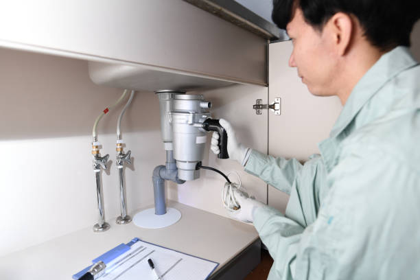 istock Asian male worker installing a disposer under the sink 1685812993