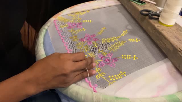 Embroidery skills of decorating cloth with threads and needlework. Close-up