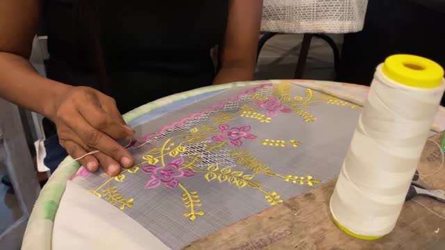 Embroidery skills of decorating cloth with threads and needlework. Close-up