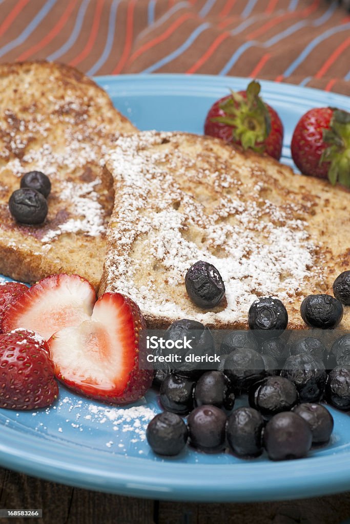 French Toast with Fruit French toast with strawberries, blueberries and powdered sugar. Blueberry Stock Photo