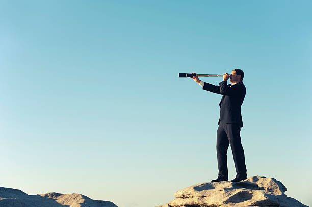 istock Businessman looking to the future with telescope 168583753