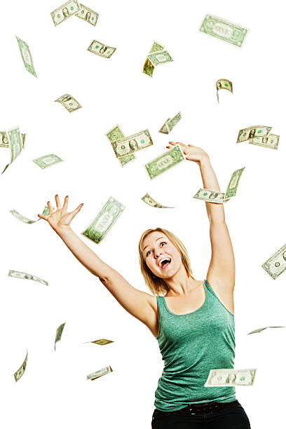 istock Dollars rain down onto a delighted laughing young blonde 168583903