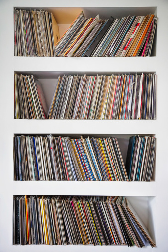 Vinyl records collection in custom wall shelves.