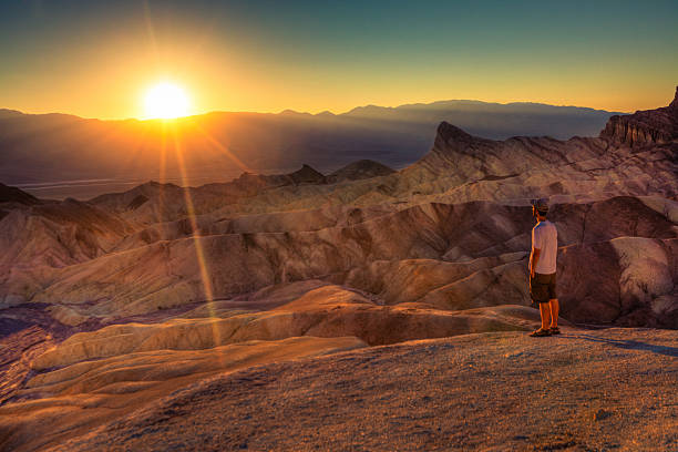 Man admiring the landscape in Death Valley Man admiring the landscape in Death Valley, California, USA. death valley desert photos stock pictures, royalty-free photos & images
