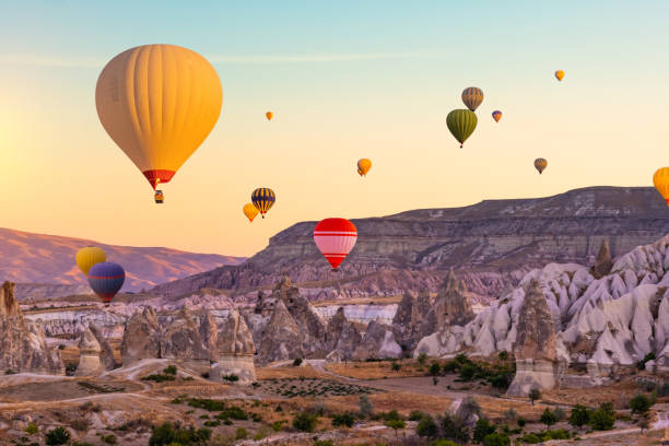 istock Hot air balloons in sunset sky 1685864379