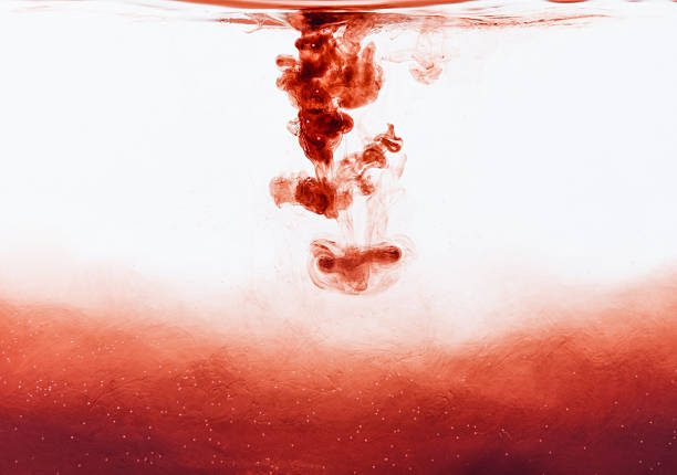 Blood drop falling into water stock photo