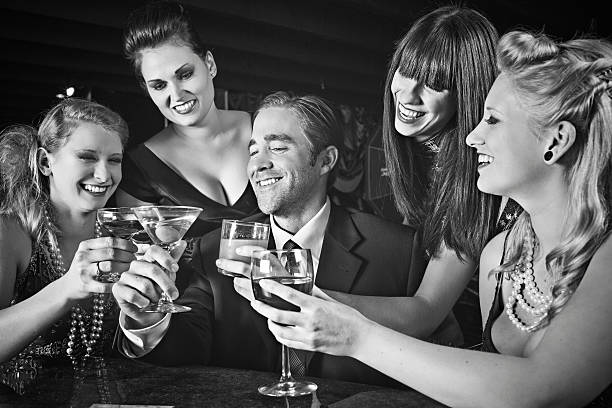 Toasting B&W picture of people toasting in the 60s . martini photos stock pictures, royalty-free photos & images