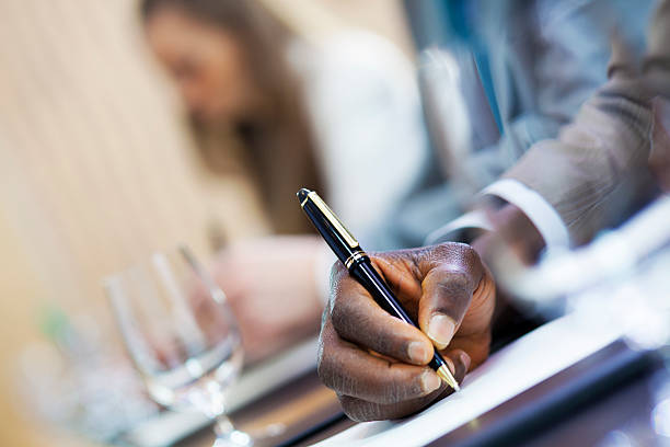 istock African american businessman  writing notes on business seminar 168586732