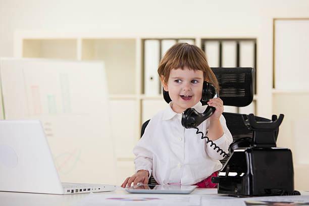 Business girl talking on the old phone Little business girl talking on the old bakellite phone and using a digital tablet while running a small business in office. girl flex stock pictures, royalty-free photos & images