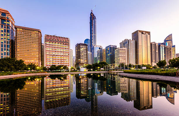 abu dhabi downtown skyline and corniche reflections - abu dhabi stok fotoğraflar ve resimler