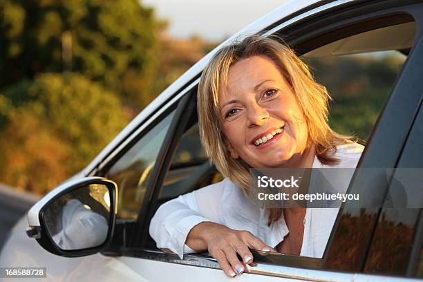 Feliz Mujer Madura En Su Coche Foto de stock y más banco de imágenes de Conducir - Conducir, Mujeres maduras, Coche deportivo