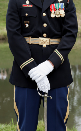 A member of the elite United States Army drill team standing at parade rest.