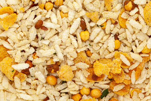 Crunchy Diet Mixture wallpaper, featuring Puffed Rice, Corn Flakes, and Curry leaves. Indian spicy snacks (Namkeen). Top view.