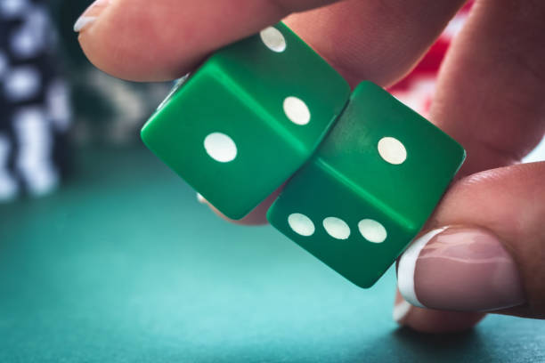 istock Green dice in woman hand 1685902745