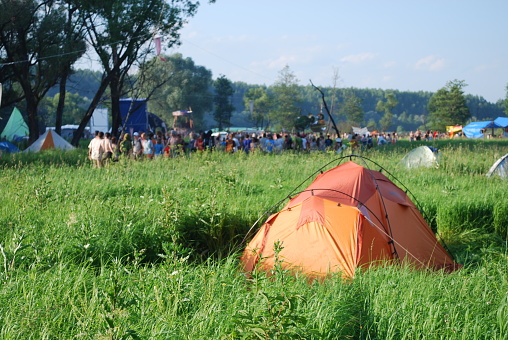 open-air tent in a field at a festival