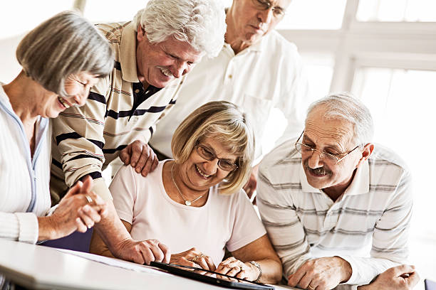 istock Group of Seniors Examine Digital Tablet 168590923