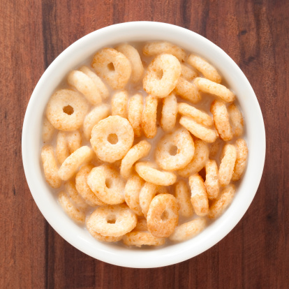 Top view of white bowl full of cereal rings