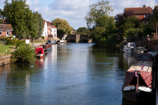 Canal boats moored on the Avon Navigation near the centre of the town of Tewkesbury, Gloucestershire, UK