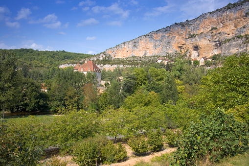 Europe, France, Quercy, Lot, old stone houses are built on the cliffs above the village at Sauliac Sur Cele