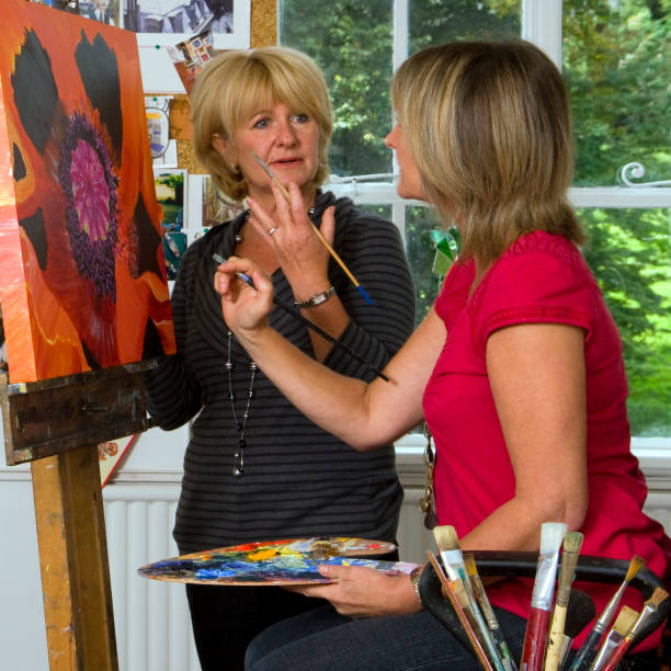 istock Woman instructing student in a fine arts class 168591645