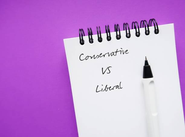 istock On pulple copy space background, pencil on note book with text written CONSERVATIVE VS LIBERAL, concept of people on different ends of political spectrum 1685941211