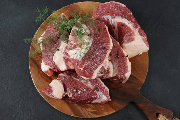 istock Fresh raw beef steaks with bone on cutting board ready for cooking Asado 1685985571
