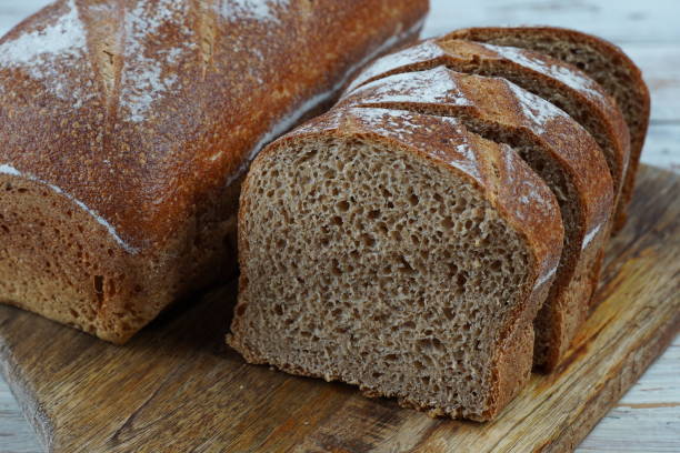 istock A sliced loaf of dark brown bread on a cutting board 1686003930