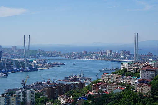 Top view of the city of Vladivostok and the Golden Horn. Panoramic view of the city of Vladivostok in summer. Cable-stayed bridge in the city of Vladivostok. Vladivostok is a city by the sea.