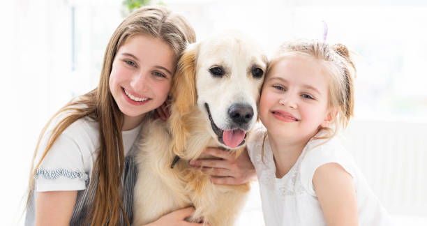 istock Smiling sisters with cute dog 1686044173