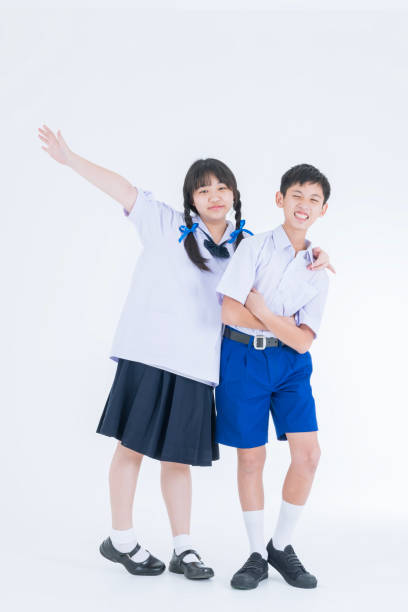 istock Asian girl and boy in student's uniform on white background. Thai students. 1686046742