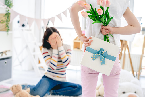 Daughter giving pleasant surprise for mother's day