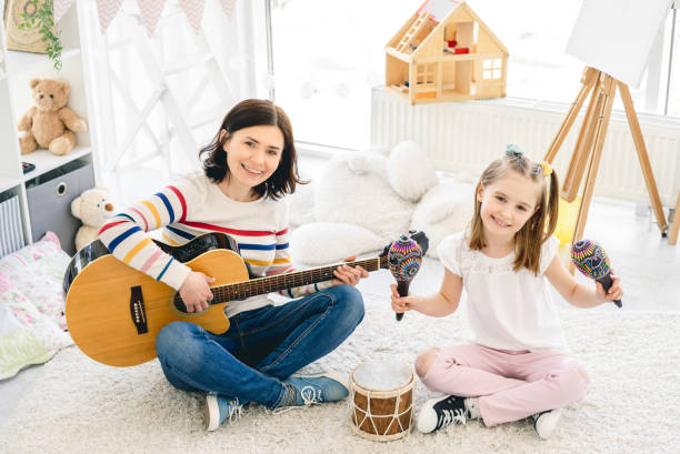 istock Girl and mother playing musical instruments 1686051457