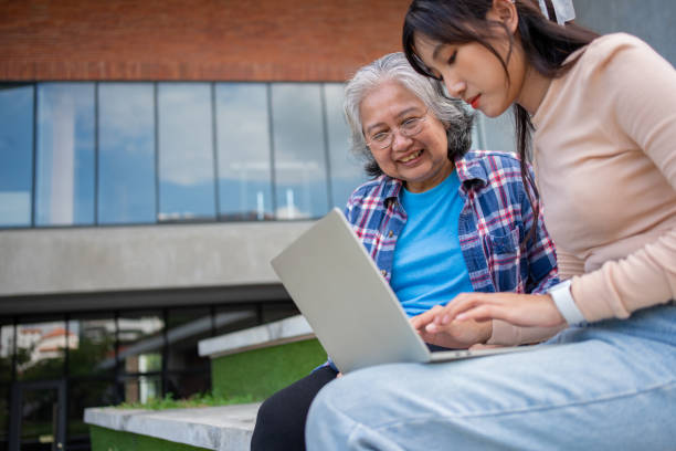 istock Focused young students listening old senior aged teachers for advise capstone project in university. Happy middle aged teacher working together with students for graduation project. 1686099521