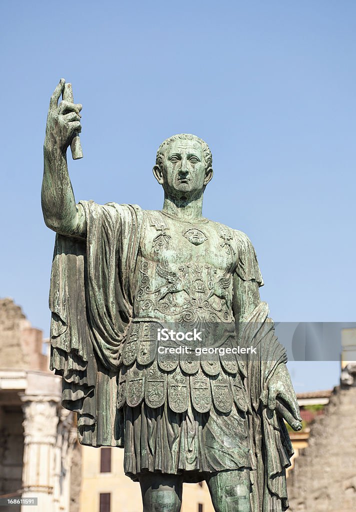 Roman Emperor Statue A heavily weathered bronze statue of a Roman Emperor holding a scroll, situated near Trajan's Forum on Via dei Fori Imperiali in central Rome. Julius Caesar - Emperor Stock Photo