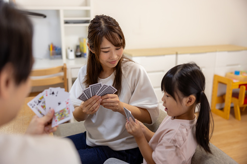 Family playing cards at home