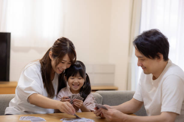 istock Family playing cards at home 1686128415