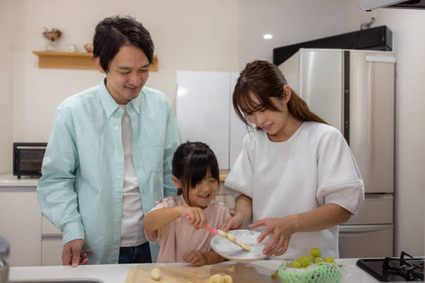 istock Family cutting apple in kitchen 1686128685