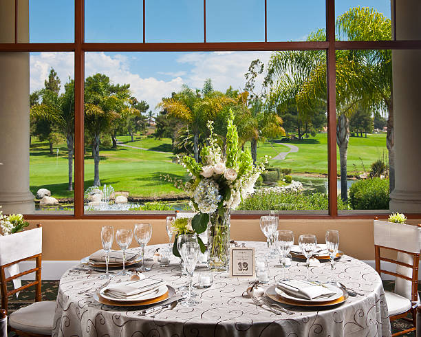 Wedding Table Setting A beautiful wedding table setting with a golf course in the background. country club stock pictures, royalty-free photos & images